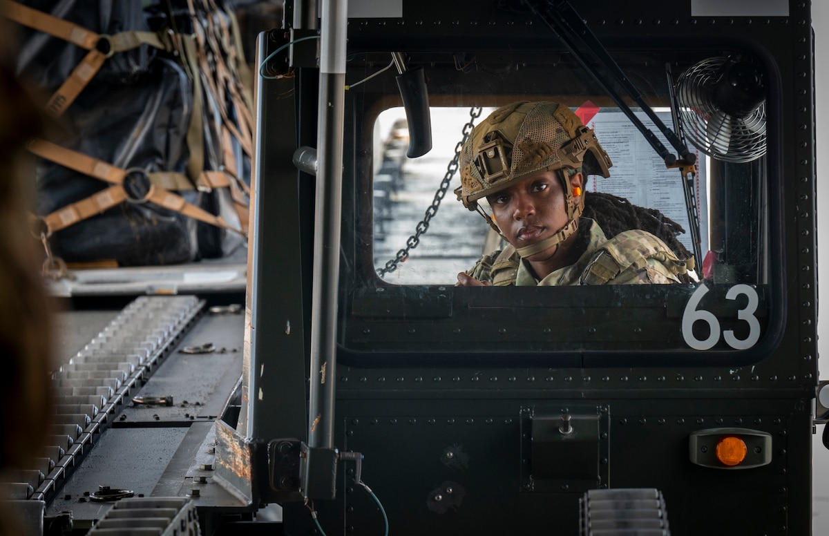 Airman watches cargo being moved