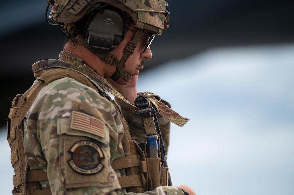 Airman adjusts radio earpiece