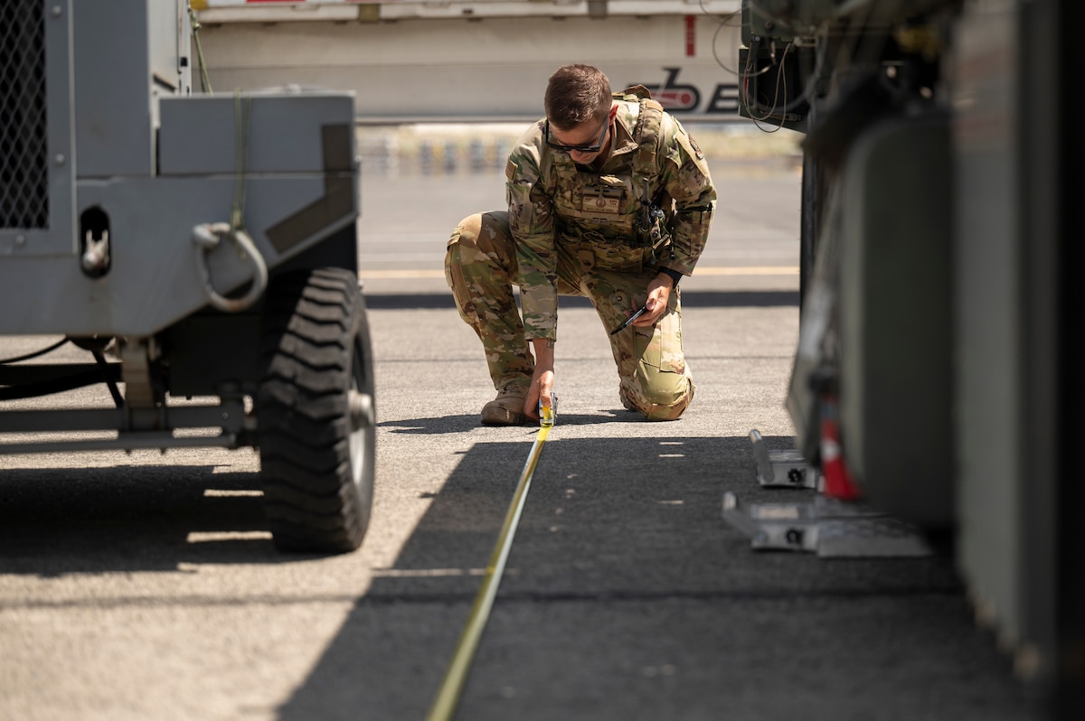 Airman measures length of vehicle