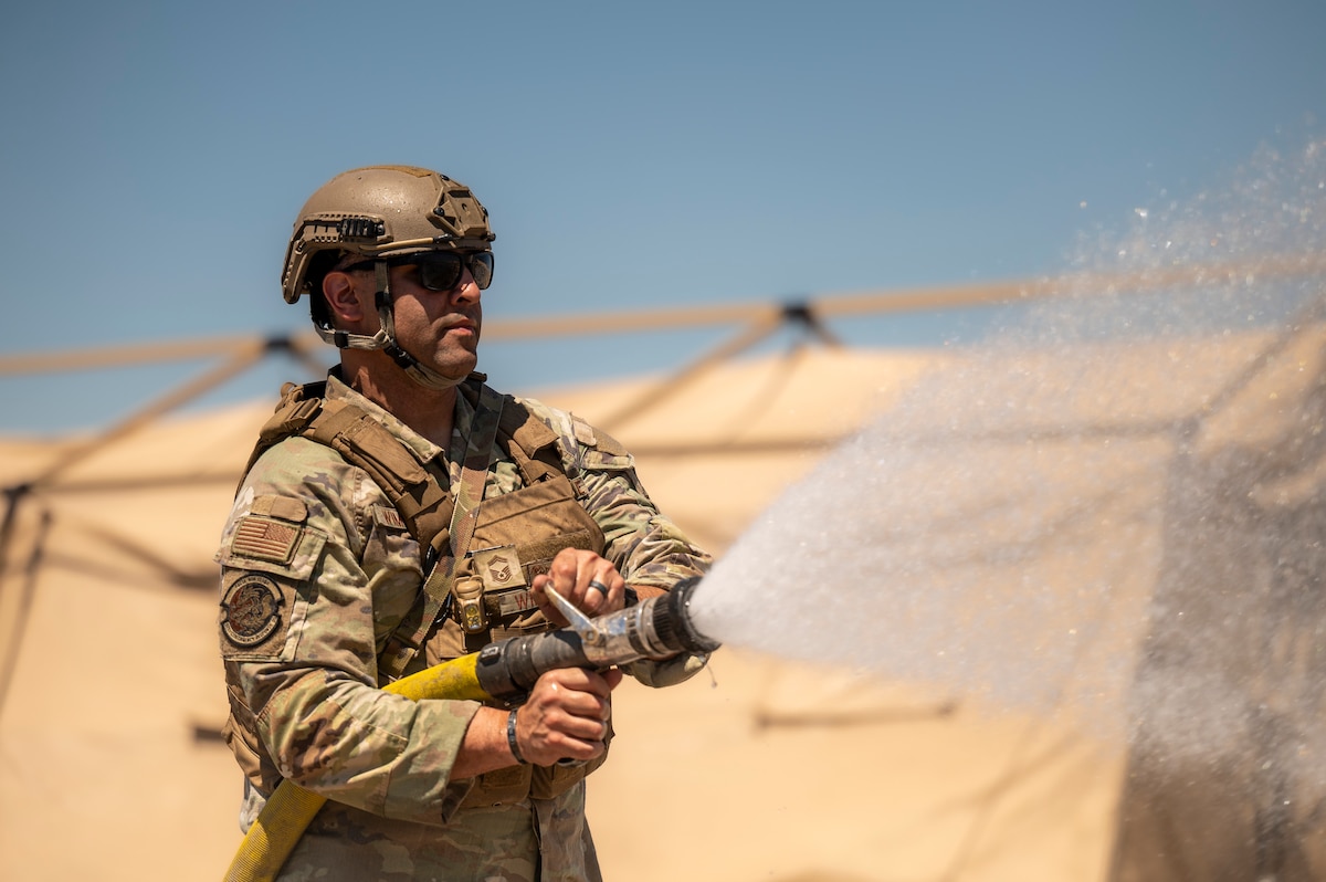 Airman uses fire hose