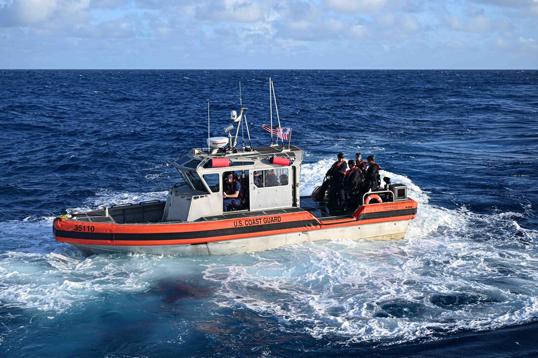 A Legend-class U.S. Coast Guard Cutter Stratton (WMSL 752) 35-foot Long Range Interceptor II small boat crew and Able Seaman  from the Republic of the Marshall Islands (RMI) Sea Patrol transit toward a fishing vessel to conduct a fisheries boarding within RMI’s exclusive economic zone, July 10, 2025.