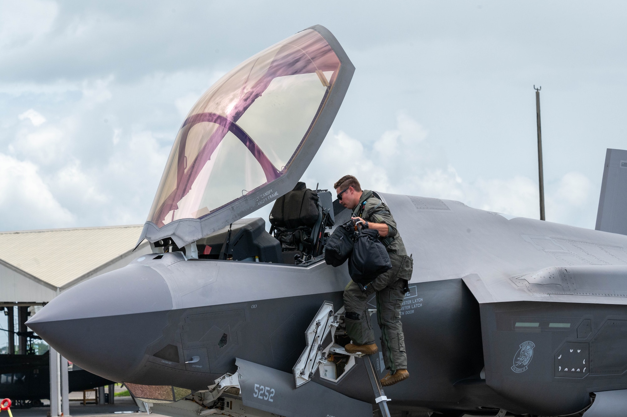U.S. Air Force Capt. Tyler Rico, 421st Mission Generation Force Element F-35A Lightning II pilot, climbs into the cockpit of his aircraft during Cope Thunder 25-2 on the flightline of Clark Air Base, Philippines, July 7, 2025. The exercise allows Airmen to train alongside Philippine Air Force counterparts, demonstrating the shared vision of maintaining security, stability, prosperity, and peace throughout the Indo-Pacific. (U.S. Air Force photo by Airman 1st Class Aden Brown)