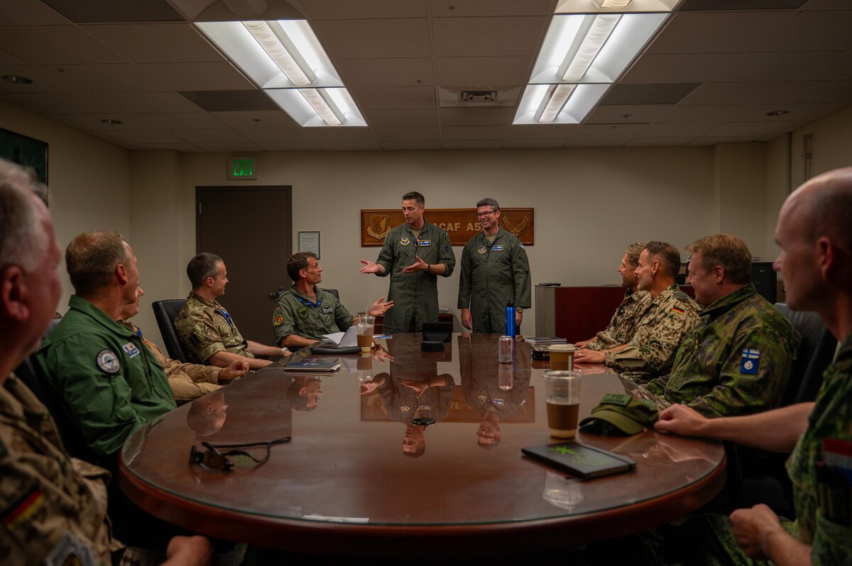 U.S. Air Force Col. Jonathan Magill (center-left), Headquarters Air Force Training and Exercise Division chief, speaks to multinational partners during an International Observer Program event at Joint Base Pearl Harbor-Hickam, Hawaii, July 18, 2025. The IOP event gave participants insight on how they could integrate into a future Resolute Force Pacific iteration to maintain stability and security and stability in the Indo-Pacific. (U.S. Air Force photo by Senior Airman Mark Sulaica)
