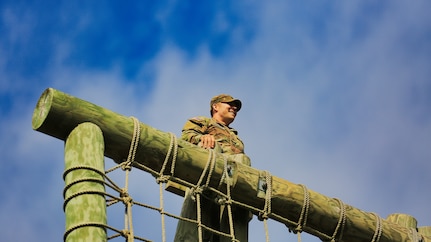 U.S. Army Dave Thomson, a public affairs specialist with the 213th Regional Support Group, Pennsylvania National Guard, scales an obstacle on the confidence course at Fort Indiantown Gap, Pennsylvania, July 22, 2025.