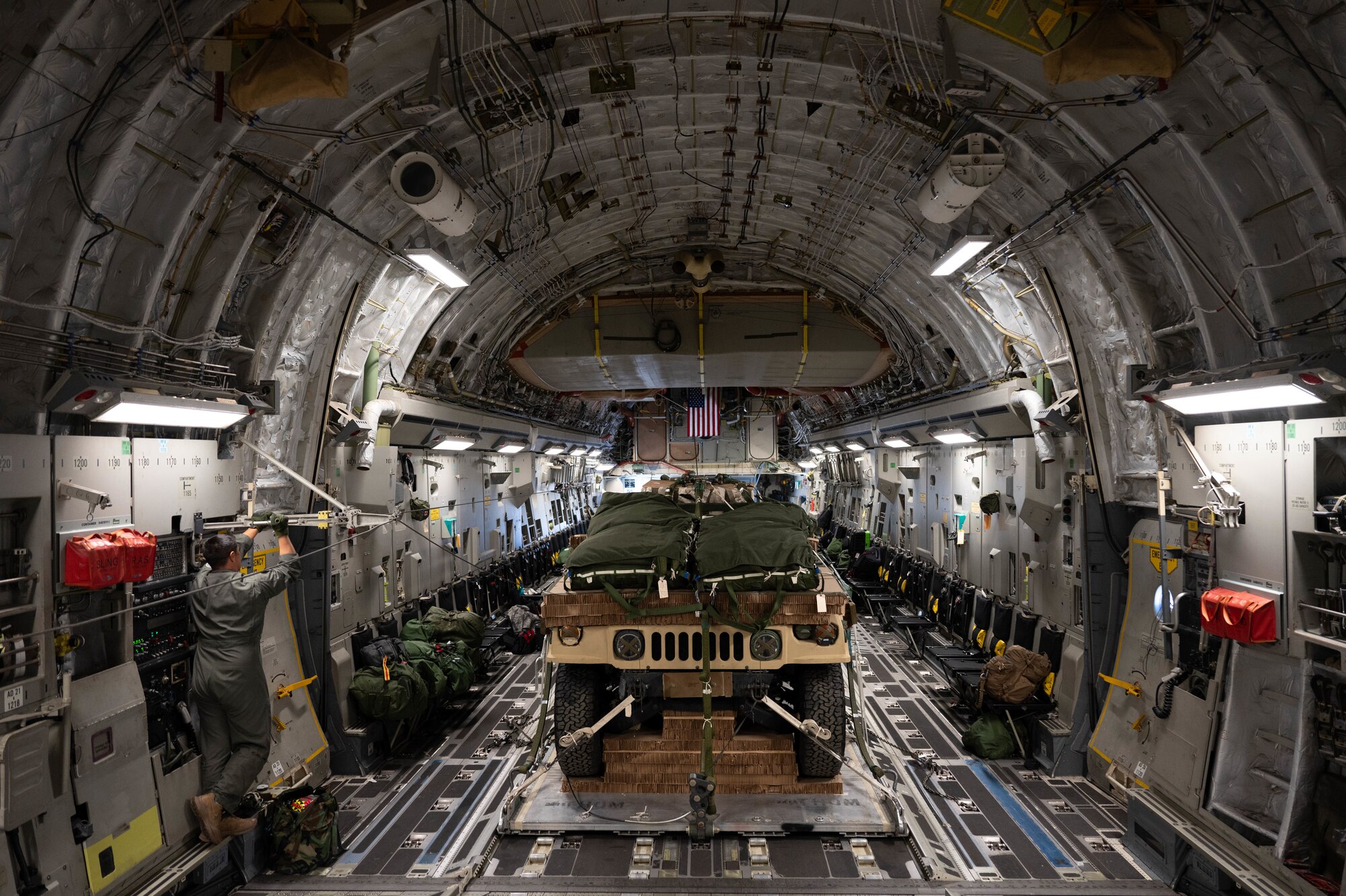 An overall photo of the inside of a C-17 with personnel and equipement.