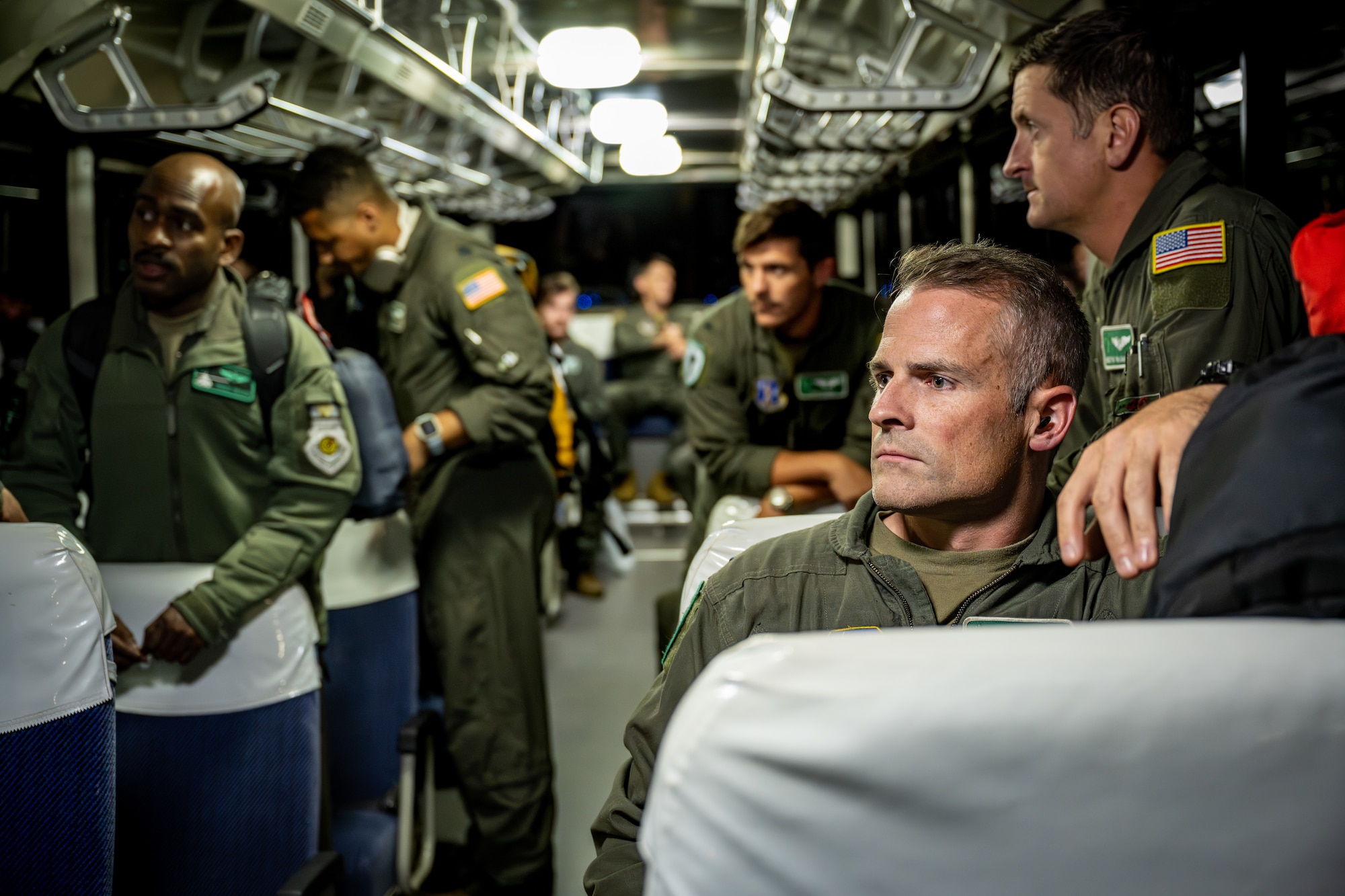 U.S. Air Force Airmen assigned to the 106th Rescue Wing wait for departure inside a shuttle bus ahead of their support for exercise Resolute Force Pacific (REFORPAC) 2025 at Misawa Air Base, Japan, July 11, 2025