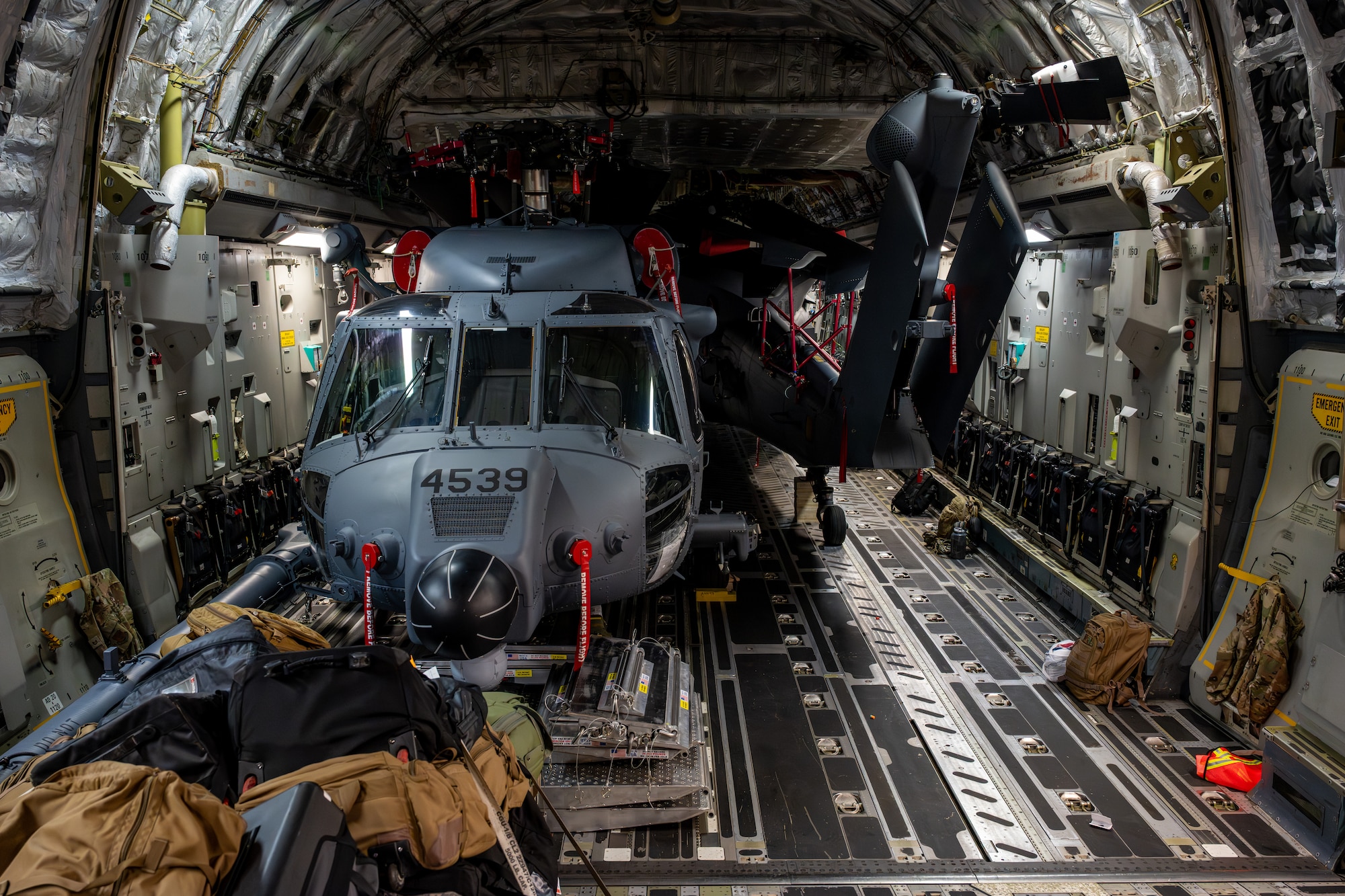 Two U.S. Air Force HH-60W Jolly Green IIs assigned to the 106th Rescue Wing sit inside a C-17 Globemaster III aircraft before being unloaded in support of exercise Resolute Force Pacific (REFORPAC) 2025