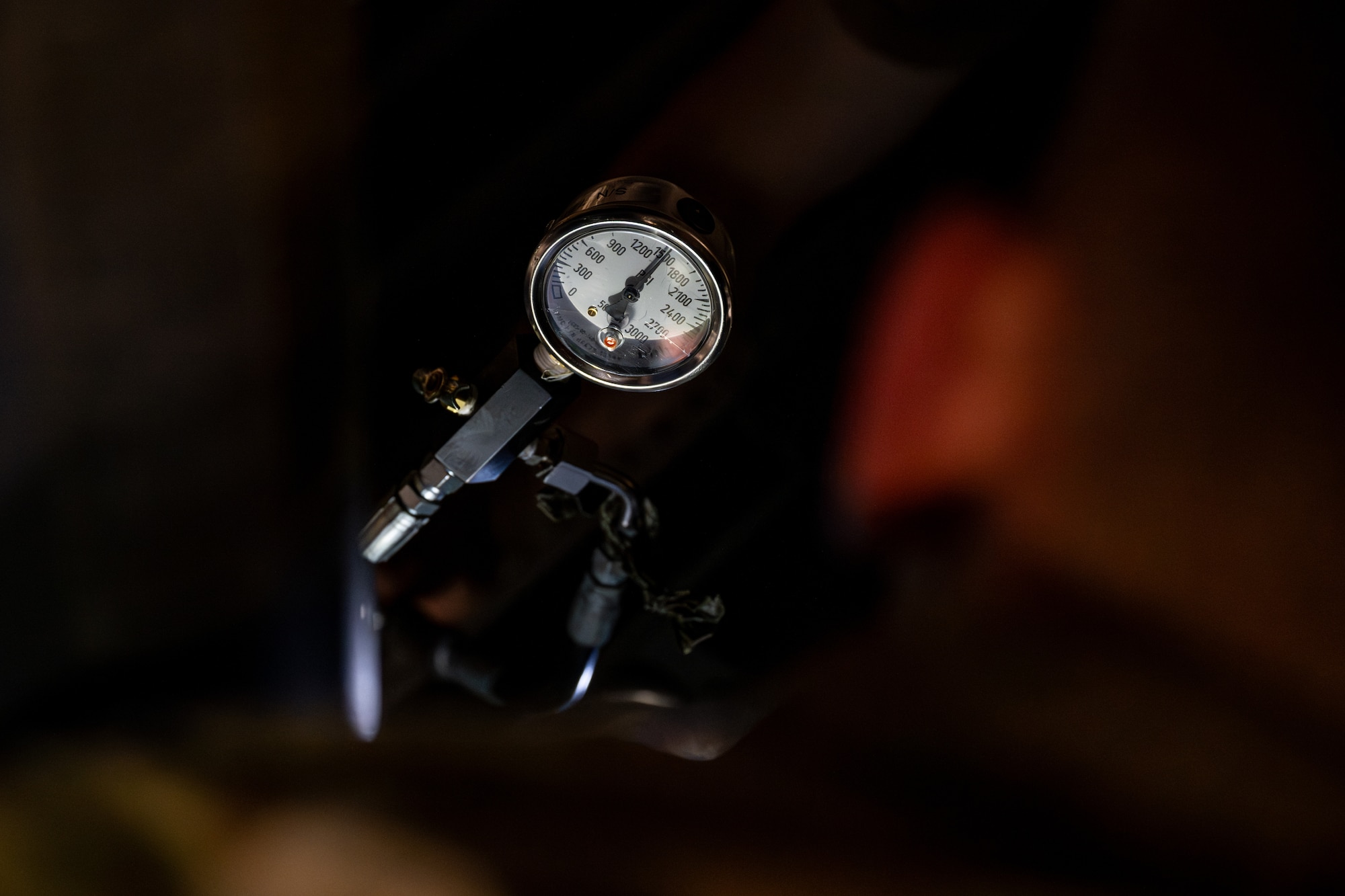 U.S. Air Force Staff Sgt. Ryan Brandon, 106th Maintenance Squadron crew chief, monitors a pressure regulator while charging nitrogen into an HH-60W Jolly Green II during exercise Resolute Force Pacific (REFORPAC) 2025