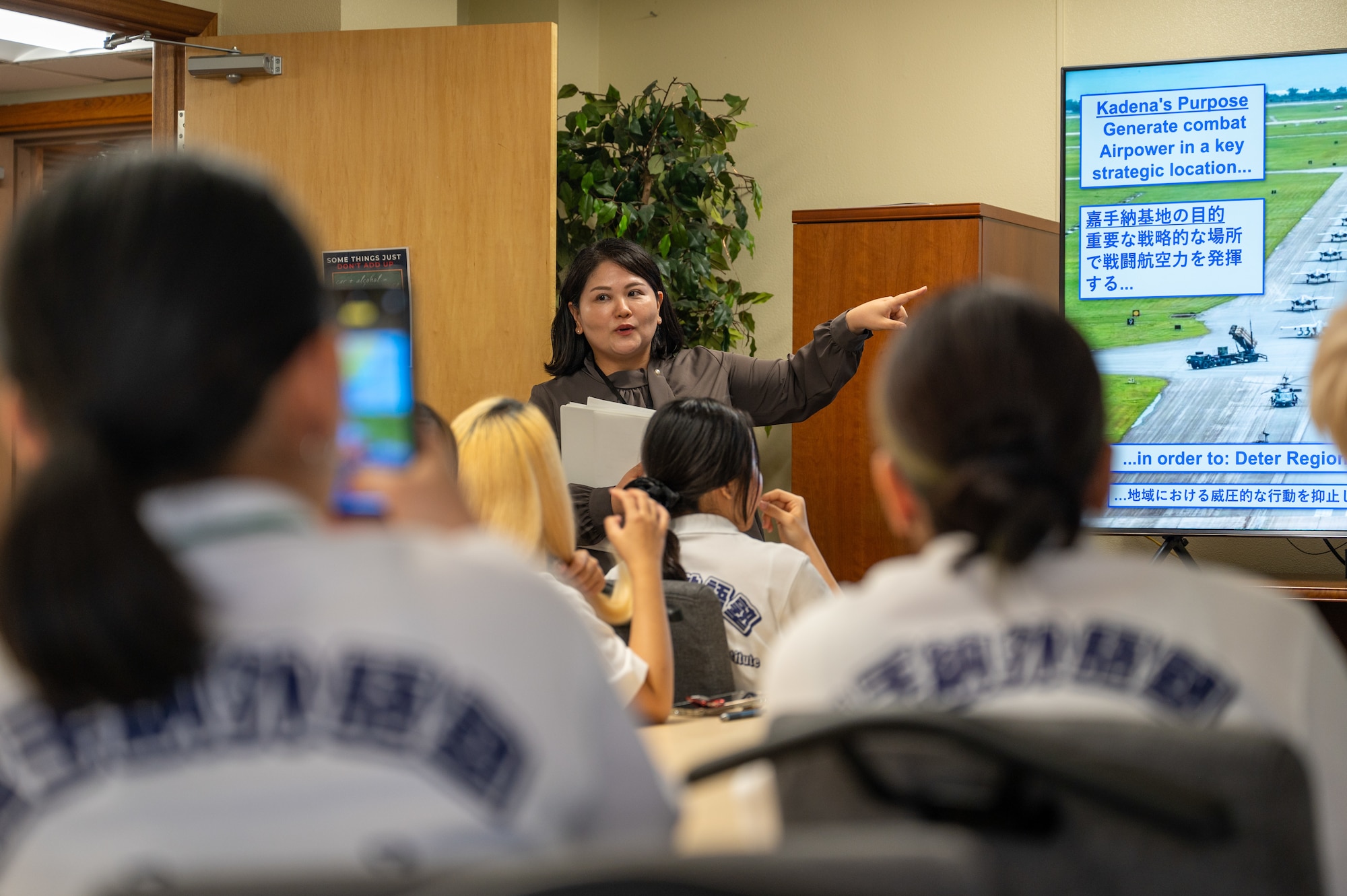 A Public Affairs community engagement member giving a mission brief to KLI students