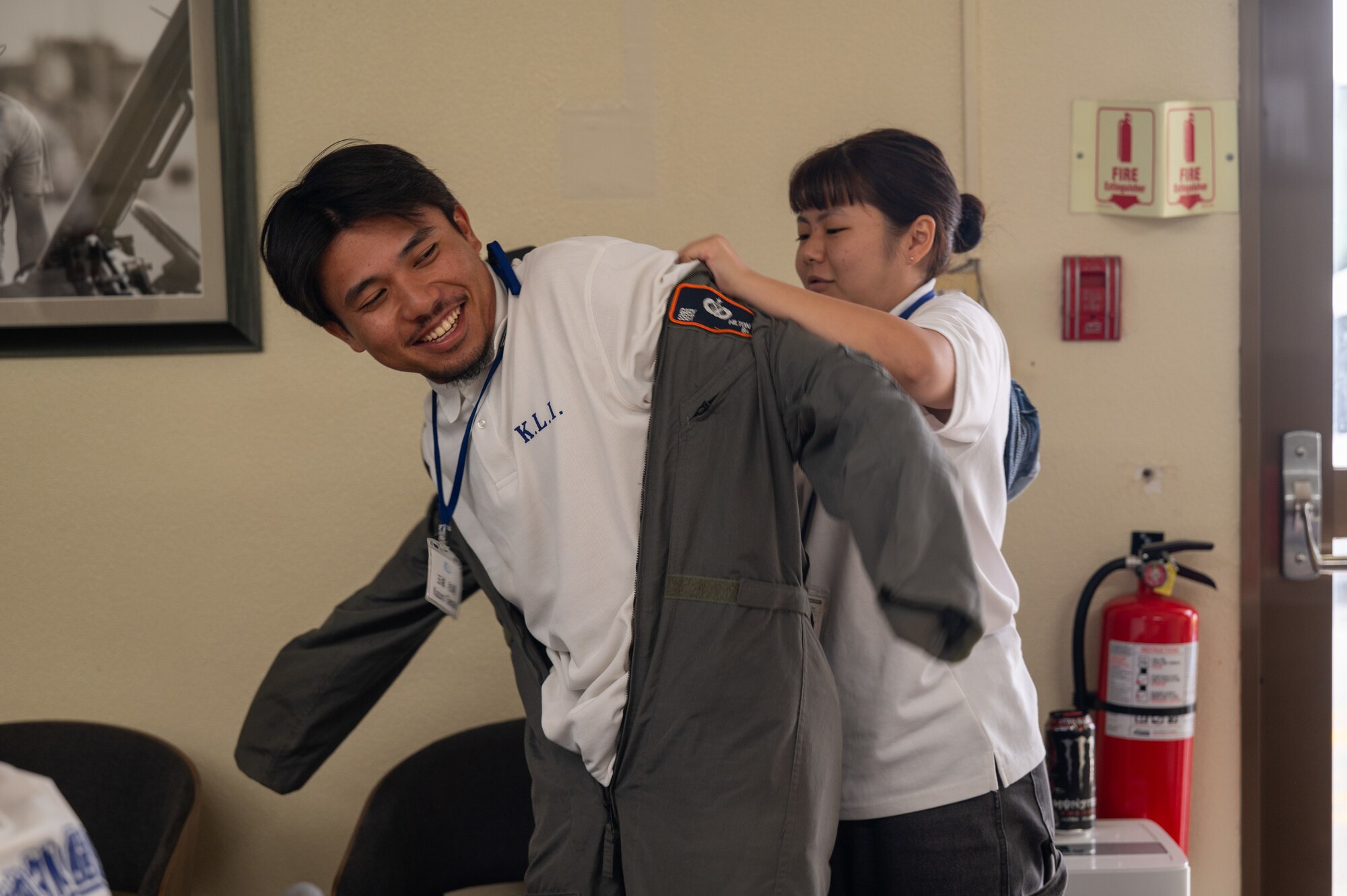 A KLI students helps another student put on military gear