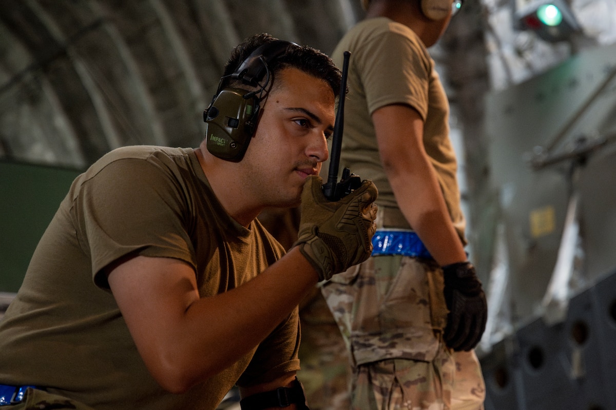 A U.S. Air Force Airman assigned to the 730th Air Mobility Squadron communicates on his radio during exercise Resolute Force Pacific (REFORPAC) 2025 at Misawa Air Base, Japan, July 18, 2025.