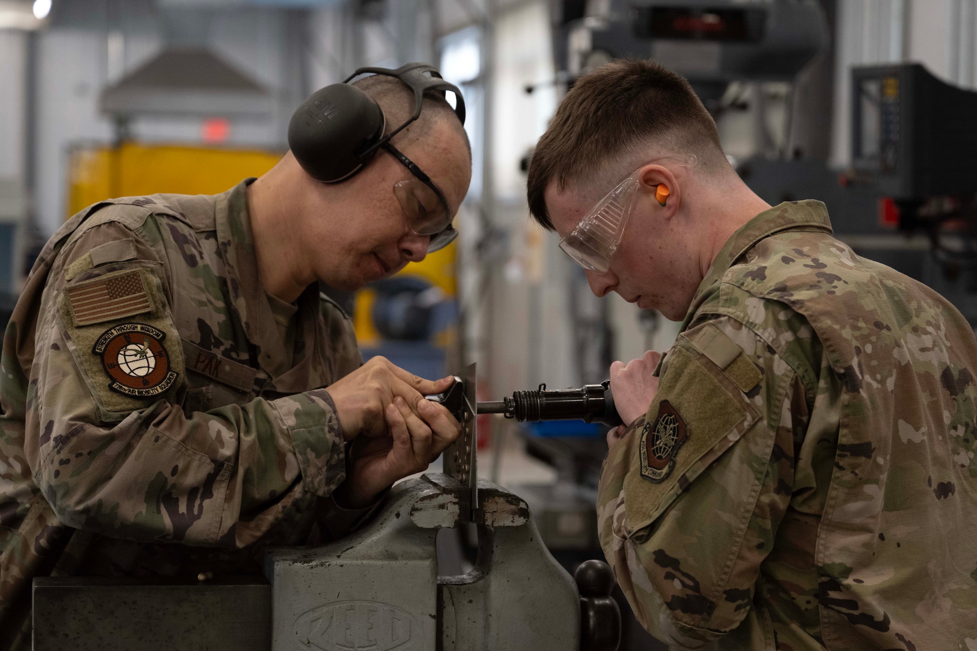 U.S. Air Force Tech. Sgt. Brian Pak, 728th Air Mobility Squadron transient aircraft noncommissioned officer in charge, and Staff Sgt. Christopher Scarpato, 728th AMS transient aircraft craftsman, perform hands-on training at Incirlik Air Base, Türkiye, July 16, 2025. The training simulates aircraft damage and guides Airmen through the full repair process, from assessment to patch installation.