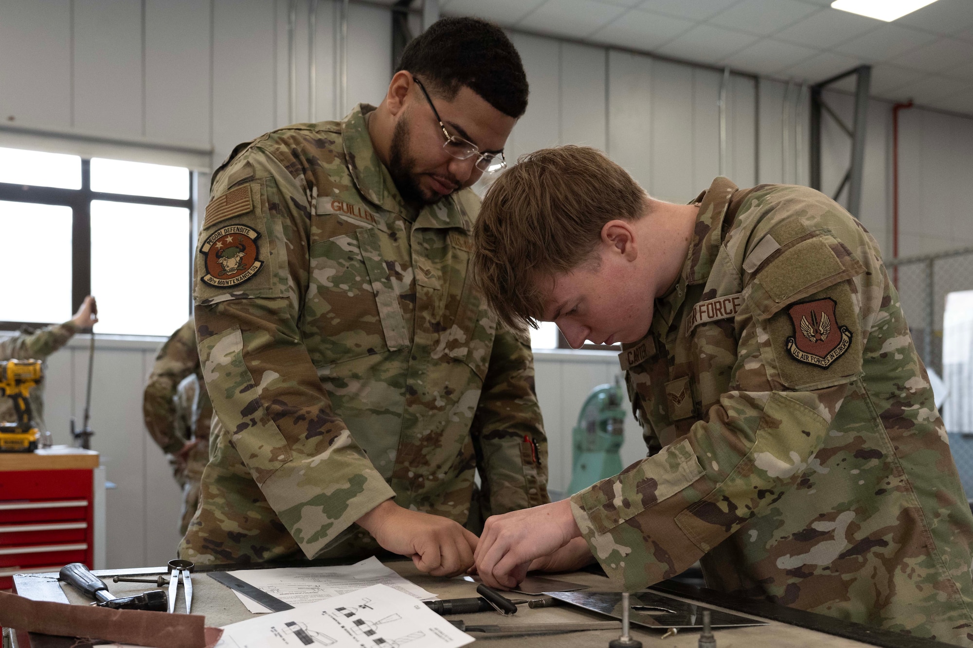 U.S. Air Force Senior Airman Desahe Guillen and Senior Airman Brandon Carter, 39th Maintenance Squadron transient alert and crash, damaged or disabled aircraft recovery journeymen, perform hands-on training at Incirlik Air Base, Türkiye, July 16, 2025. The training simulates aircraft damage and guides Airmen through the full repair process, from assessment to patch installation.