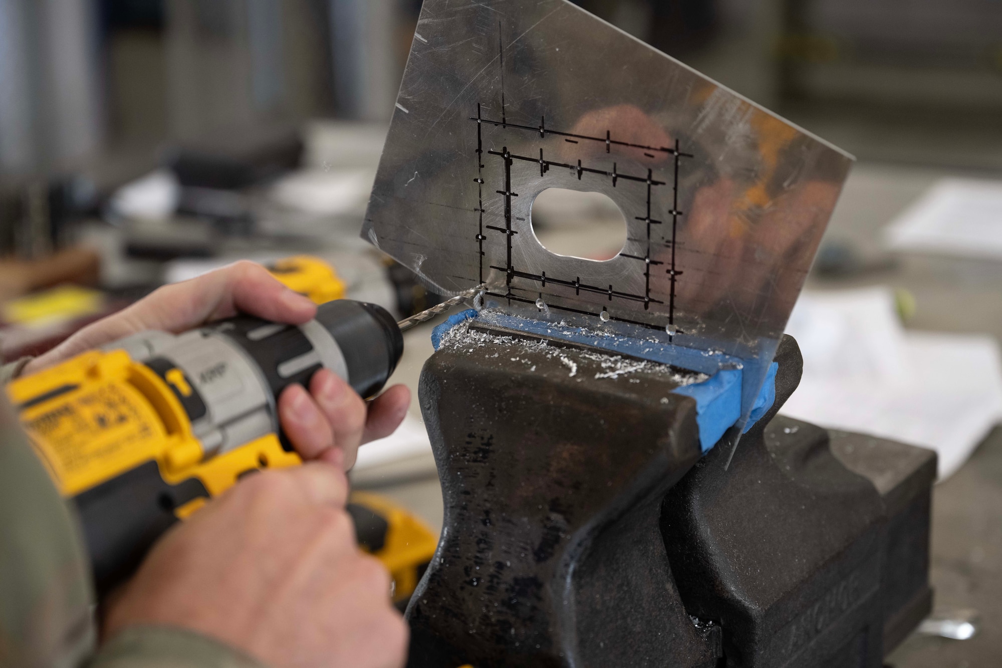 U.S. Air Force Tech. Sgt. Jeremy Huether, 728th Air Mobility Squadron transient aircraft craftsman, drills into a metal sheet at Incirlik Air Base, Türkiye, July 16, 2025. The training focuses on core repair techniques that prepare Airmen to restore aircraft functionality in deployed environments.