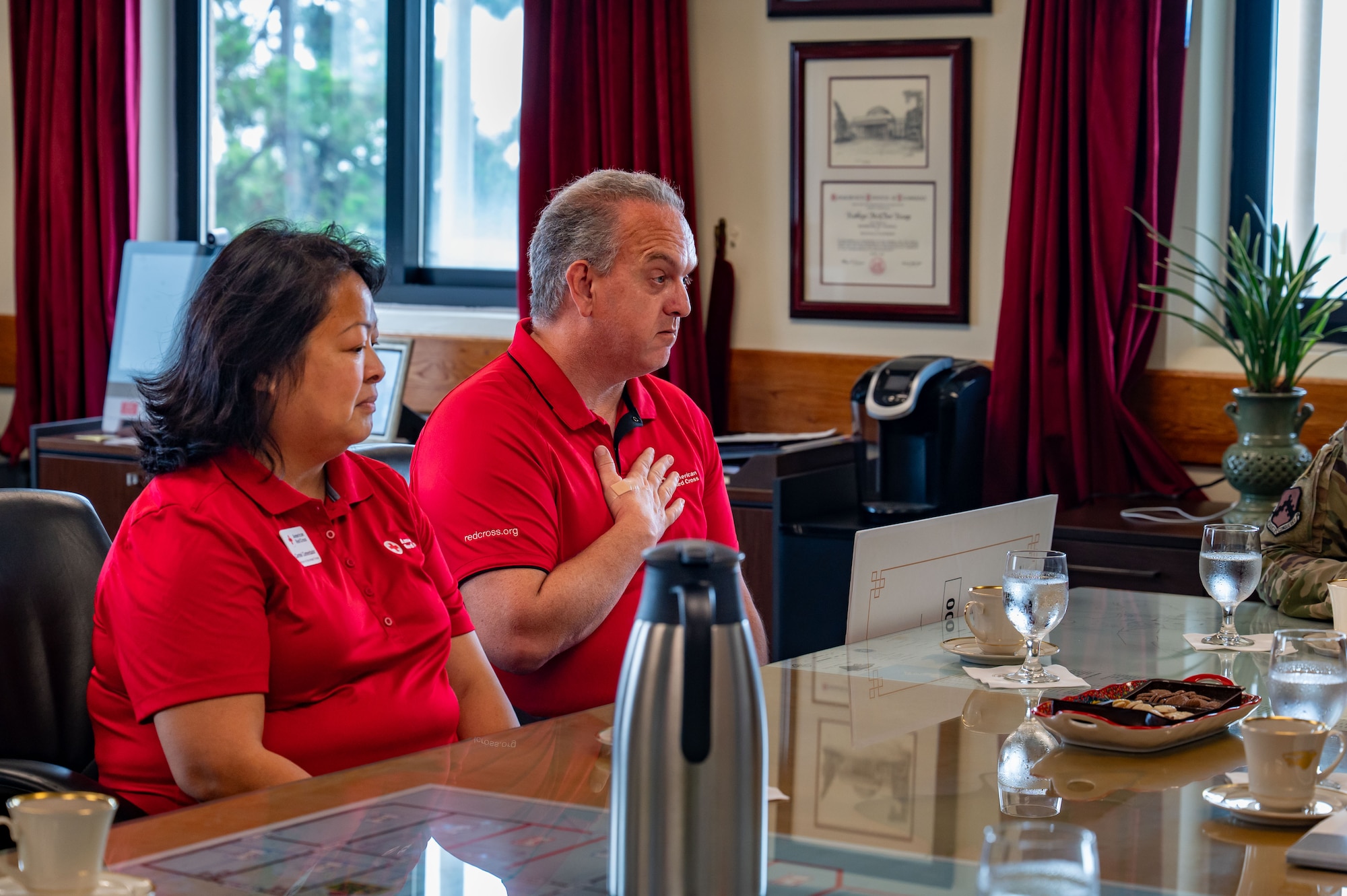 Brian Mumahan, American Red Cross Service to the Armed Forces Korea region regional program director, and Carmel Comendador, American Red Cross Service to the Armed Forces Korea region regional program specialist, address the room regarding the donation made by the Korean-American Gunsan Alliance