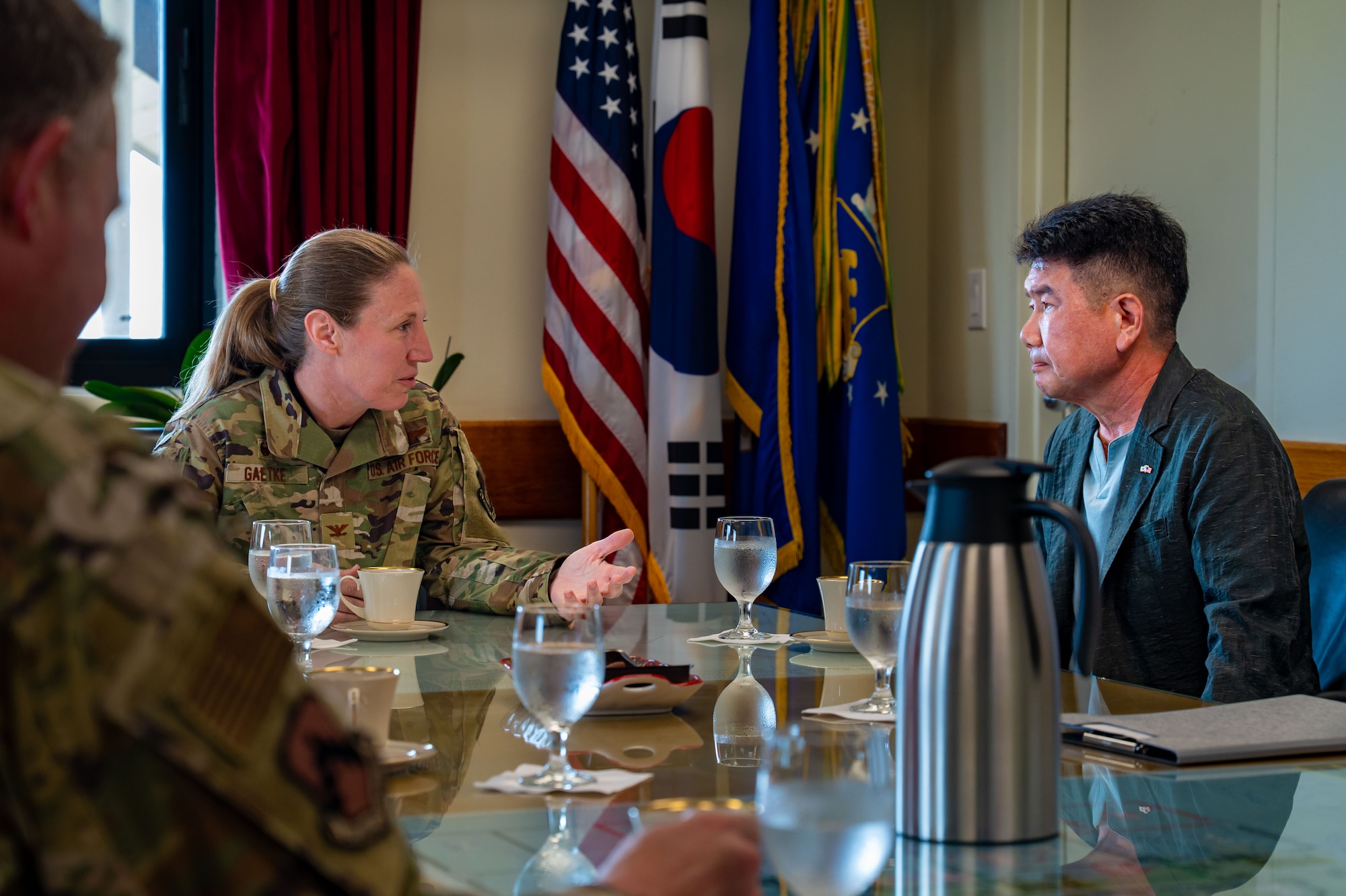 U.S. Air Force Col. Kathryn "Wolf" Gaetke, 8th Fighter Wing commander, speaks with Choi In-t’ae, Korean-American Gunsan Alliance chairman, about the donation made by KAGA to assist with Texas flood relief efforts