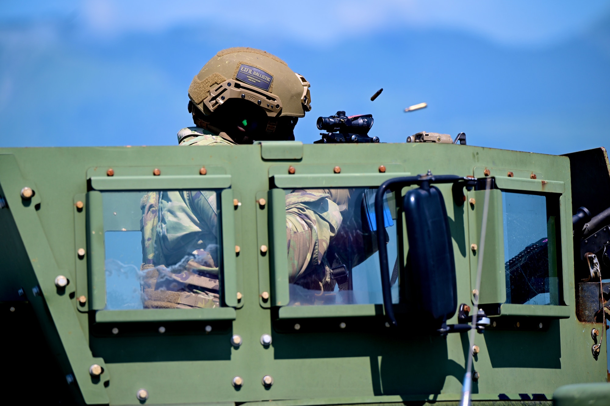 Airman fires firearm at enemy forces.
