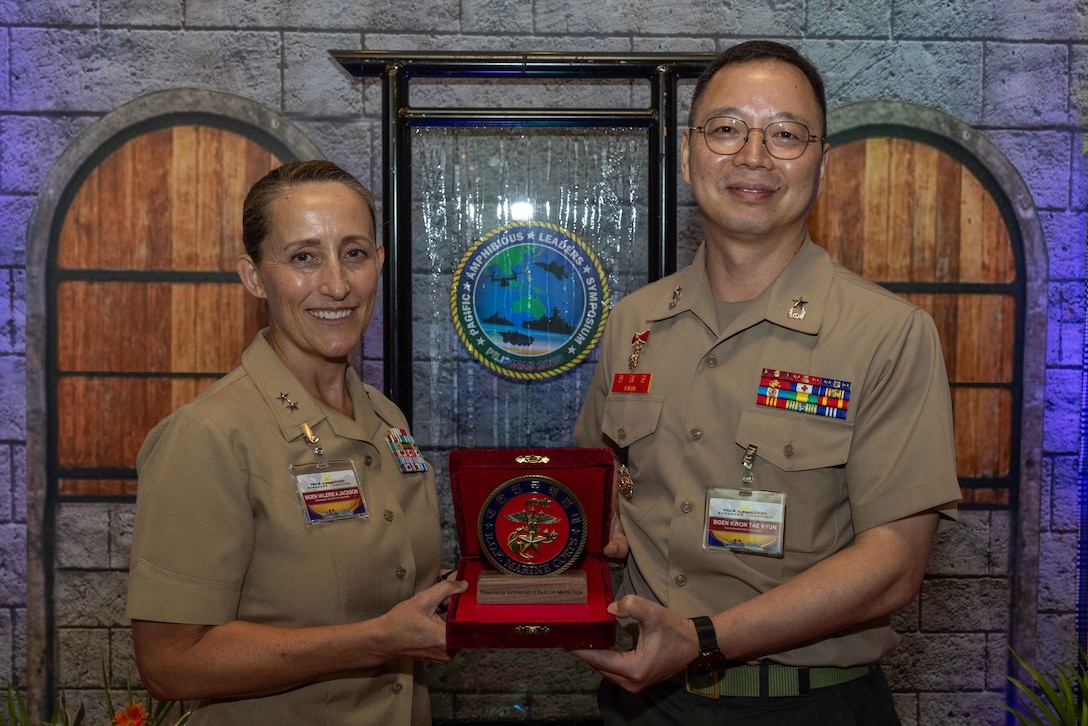 U.S. Marine Corps Maj. General Valerie Jackson, left, commander, Marine Corps Forces Korea, and Republic of Korea Marine Corps Brig. Gen. Kwon Tae Kyon, special assistant, pose for a photo following a gift exchange prior to the closing ceremony at the 11th iteration of the Pacific Amphibious Leaders Symposium, Manila, Philippines, July 10, 2025. Through discussions, engagements, and presentations, PALS enhances cooperation, tackles common threats, protects shared resources, and maintains sovereignty in the Indo-Pacific. This year's symposium hosts senior leaders from 23 participating nations who are committed to a free and open Indo-Pacific, with the objective of strengthening and developing regional relationships.