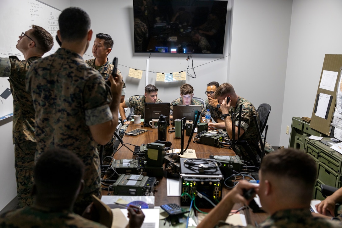 U.S. Marines with 2nd Air Naval Gunfire Liaison Company, II Marine Expeditionary Force Information Group, conduct simulated battle tracking and call for support inside the Fire Support Coordination Center during Burmese Chase 25, at Marine Corps Base Camp Lejeune, North Carolina, July 23, 2025. Burmese Chase is an annual U.S. led, multi-lateral training exercise comprised of integrating ground and air fires, infantry tactics and naval gunfire alongside NATO allies to enhance combat readiness and interoperability. (U.S. Marine Corps photo by Cpl. Marc Imprevert)