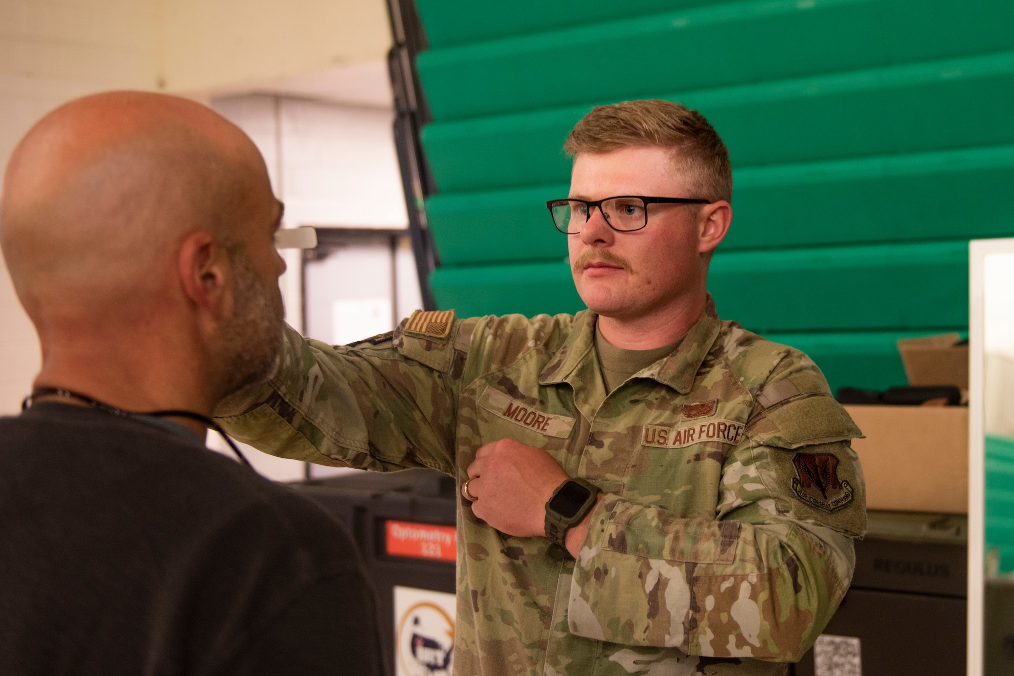 U.S. Air Force Senior Airman Thomas Moore, an optometry technician, assigned to the 90th medical group, Wy., measures a local resident for a new pair of glasses during Operation Healthy Tennessee, Rhea County Middle School, Evensville, Tenn., July 10, 2025. Operation Healthy Tennessee provides no-cost medical, dental, vision and veterinary services to the residents of Bledsoe and Rhea County, as well as the surrounding areas while satisfying training requirements for active-duty, reserve and Air National Guard service members and units. (U.S. Air National Guard photo by SSgt. Sarah Stalder Lundgren)