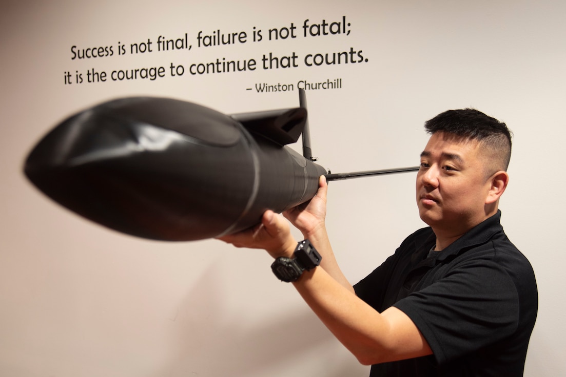 U.S. Air Force Staff Sgt. Daniel S. Kim examines the 3D-printed fuselage of a Blackbird drone July 2, 2025, at Joint Base Andrews, Md.