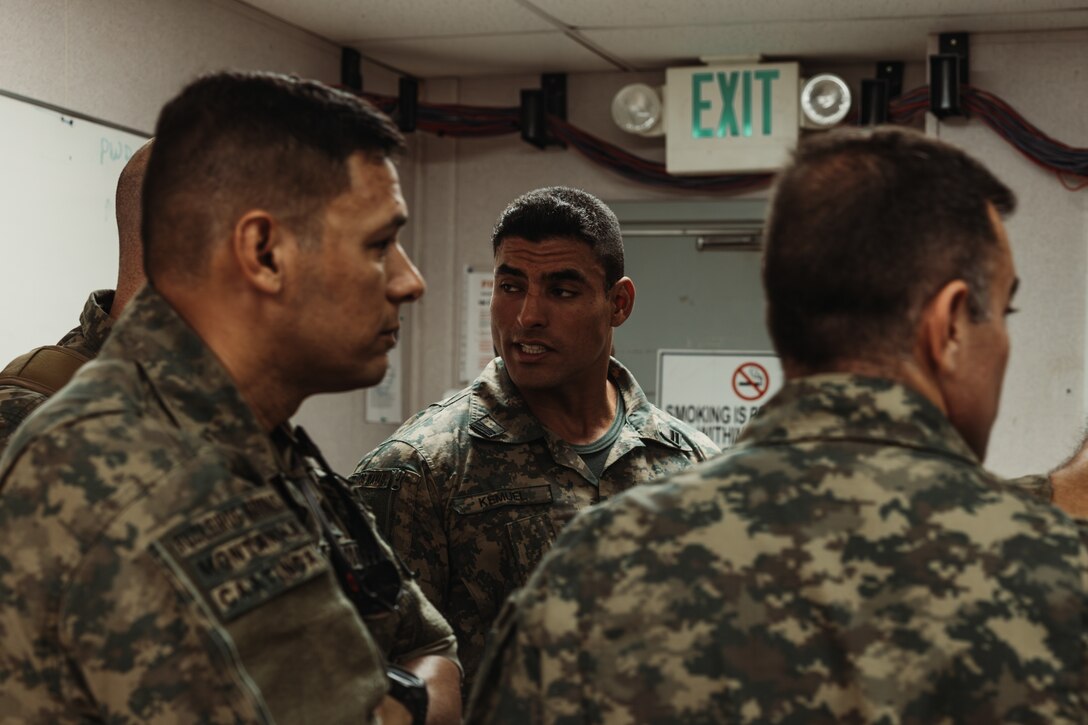 Corpo de Fuzileiros Navais (Brazilian Marine Corps ) marines observe U.S. Marines with Tactical Training and Exercise Control Group, Marine Air Ground Task Force Training Command, Marine Corps Air Ground Combat Center, as they operate a Fire Support Team Exercise during  Service Level Training Exercise 4-25 on Camp Wilson, Twentynine Palms, California, July 17, 2025. The Brazilian Marines were part of a delegation that visited to observe the SLTE process, designed, enabled, and overseen by the Tactical Training and Exercise Control Group, in order to improve their own standard operating procedures and increase operability with their U.S. partners. (U.S. Marine Corps photo by LCpl Dominic Spence)