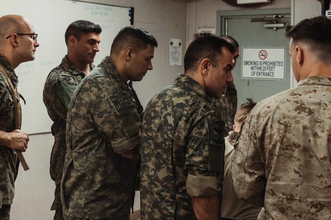 Corpo de Fuzileiros Navais (Brazilian Marine Corps ) marines observe U.S. Marines with Tactical Training and Exercise Control Group, Marine Air Ground Task Force Training Command, Marine Corps Air Ground Combat Center, as they operate a Fire Support Team Exercise during  Service Level Training Exercise 4-25 on Camp Wilson, Twentynine Palms, California, July 17, 2025. The Brazilian Marines were part of a delegation that visited to observe the SLTE process, designed, enabled, and overseen by the Tactical Training and Exercise Control Group, in order to improve their own standard operating procedures and increase operability with their U.S. partners. (U.S. Marine Corps photo by LCpl Dominic Spence)