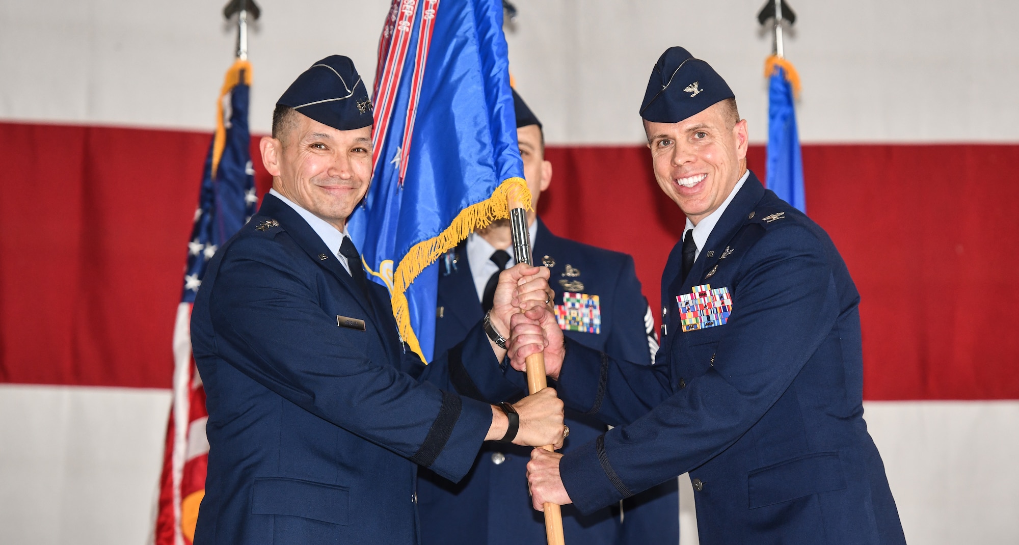 Lt. Gen. Thomas Hensley, 16th Air Force commander, hands the guidon to Col. Hank Chilcoat, 55th Weather Wing commander, during the 557th Weather Wing assumption of command ceremony at Offutt Air Force Base, July 22, 2025.   (U.S. Air Force photo by Chad Watkins)