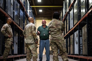 Members of the U.S. Air Force Reserve Senior Enlisted Council talk with Glenn Johnson, Air Force Material Command management analyst, during a base tour at Grissom Air Reserve Base, Ind., June 24, 2025. Speaking with base personnel guides the RSEC’s decision-making process, allowing for policies and initiatives that drive a more combat-ready force. (U.S. Air Force photo by Senior Airman Elise Faurote)