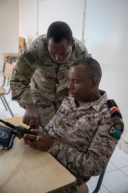 U.S. Army 1st Lt. Thiery Byishimo, signal officer with the 149th Signal Company, Kentucky Army National Guard, participates in a radio communication knowledge exchange with Djiboutian soldiers at the Djiboutian signal corp compound in Djibouti City, Djibouti, July 14, 2025.
