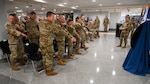 Service members stand and replace their patches with new ones.