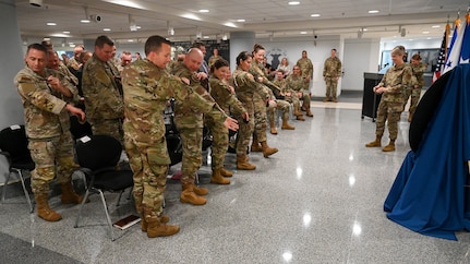 Service members stand and replace their patches with new ones.