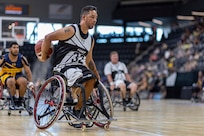 U.S. Army Retired Spc. Anthony Farve gets out on a fastbreak in the wheelchair basketball game against Team Navy during the 2025 Department of Defense Warrior Games at Colorado Springs, Colorado, July 20, 2025.