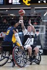 U.S. Army Staff Sgt. Tyler Pollard shoots over a defender in the wheelchair basketball game against Team Navy during the 2025 Department of Defense Warrior Games at Colorado Springs, Colorado, July 20, 2025.