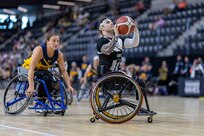 U.S. Army Retired Spc. JP Lane shoots the ball during the wheelchair basketball game against Team Navy at the 2025 Department of Defense Warrior Games at Colorado Springs, Colorado, July 20, 2025.