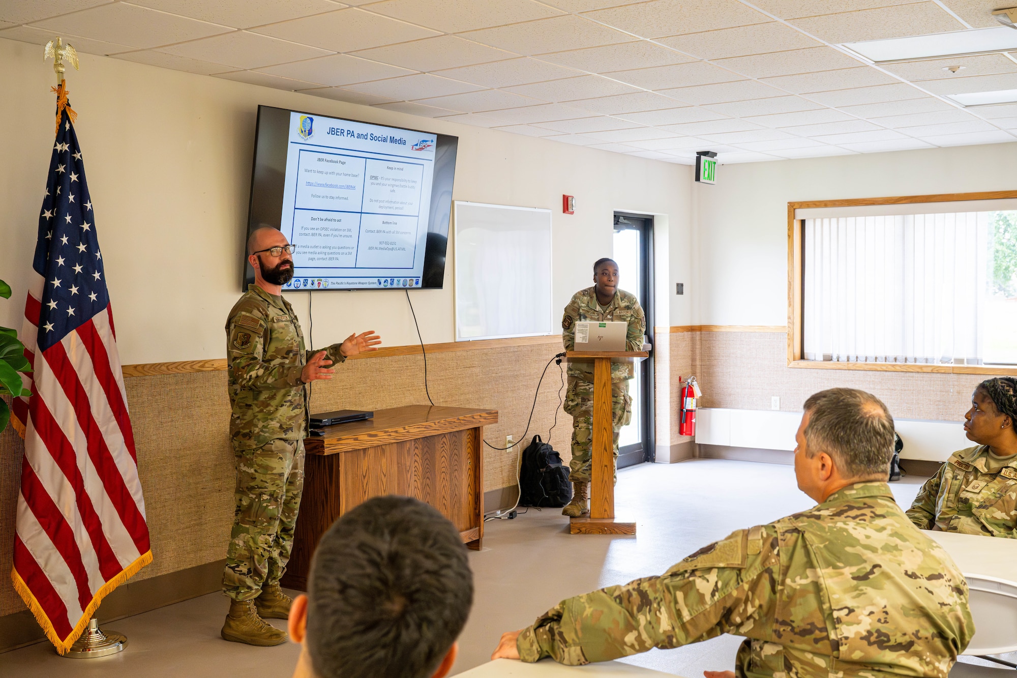 U.S. Air Force Staff Sgt. Micheal Pfeiffer, 673d Air Base Wing public affairs specialist, briefs Air National Guardsmen during a processing brief for exercise Resolute Force Pacific on Joint Base Elmendorf-Richardson, Alaska, July 11, 2025.