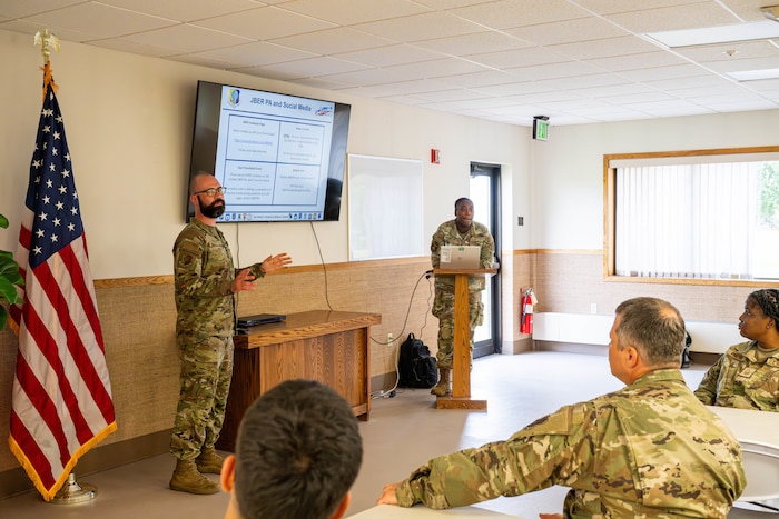 U.S. Air Force Staff Sgt. Micheal Pfeiffer, 673d Air Base Wing public affairs specialist, briefs Air National Guardsmen during a processing brief for exercise Resolute Force Pacific on Joint Base Elmendorf-Richardson, Alaska, July 11, 2025.