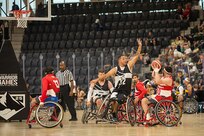 U.S. Army Retired Spc. Anthony Farve extends to block a scoring attempt by Team Marine Corps in a wheelchair basketball game at the 2025 Department of Defense Warrior Games in Ed Robson Arena, Colorado Springs, Colorado, July 19, 2025.