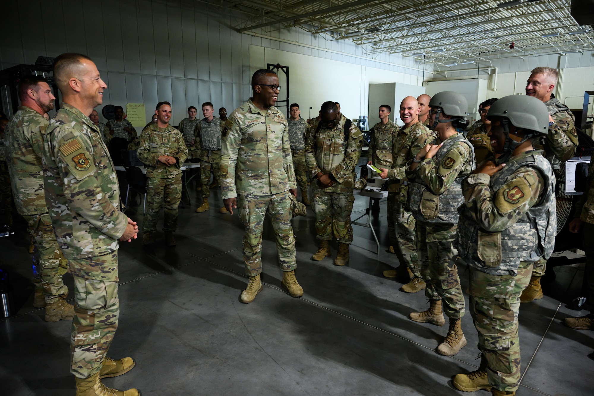 Lt. Gen. Stacey Hawkins stands surrounded by Airmen.
