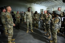 Lt. Gen. Stacey Hawkins stands surrounded by Airmen.