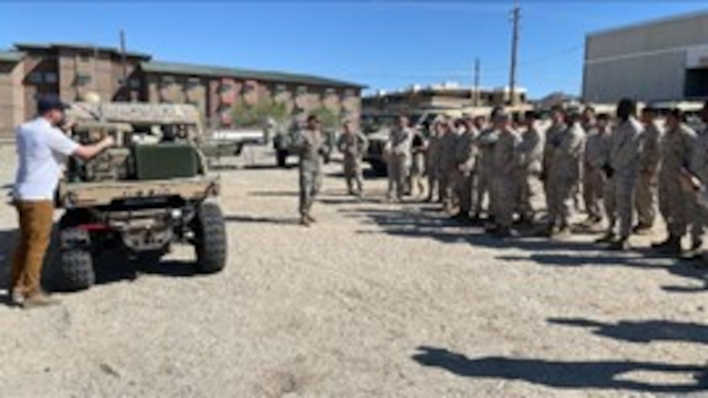 U.S. Naval Research Laboratory Principal Investigator Kevin Cronin (left) and U.S. Marine Corps Expeditionary Energy Office Science and Technology Analyst Capt. Joshua Ashley (center) train Marines from the 7th Marine Regiment on the warfighting utility of hydrogen fuel cell systems during an exercise at Marine Corps Air Ground Combat Center Twentynine Palms, Cali., May 20, 2025.