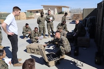U.S. Naval Research Laboratory Principal Investigator Kevin Cronin (left) trains Marines from Marine Wing Support Squadron 371 on the operation of the Hydrogen Small Unit Power (H-SUP) at Marine Corps Air Station Yuma, Arizona, Feb. 19, 2025. (U.S. Navy photo)