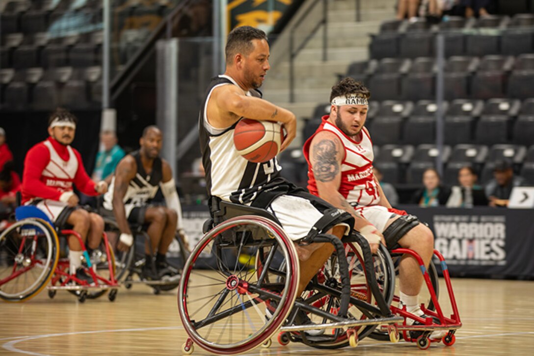 U.S. Army Retired Spc. Anthony Farve executes a clever move during a wheelchair basketball game against Team Marine Corps at the 2025 Department of Defense Warrior Games in Ed Robson Arena, Colorado Springs, Colorado, July 19, 2025.