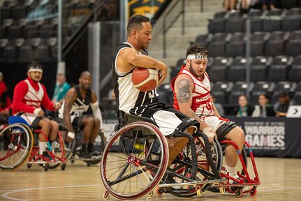 U.S. Army Retired Spc. Anthony Farve executes a clever move during a wheelchair basketball game against Team Marine Corps at the 2025 Department of Defense Warrior Games in Ed Robson Arena, Colorado Springs, Colorado, July 19, 2025.