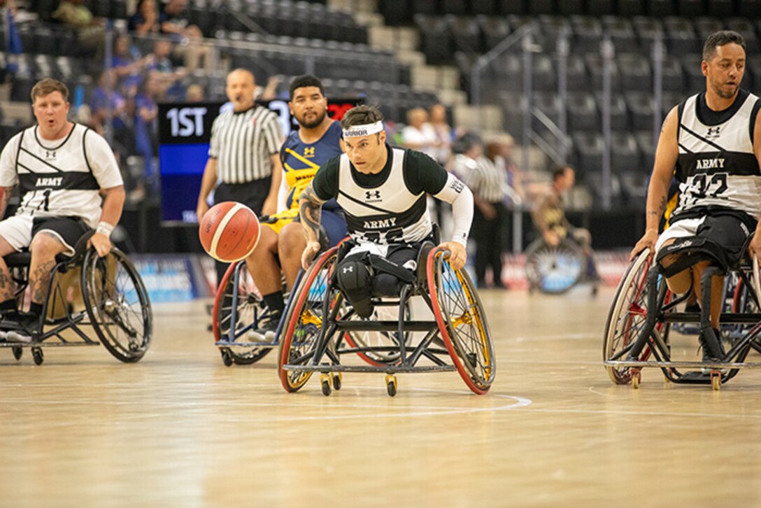 U.S. Army Retired Spc. JP Lane chases after the ball during a fast-paced wheelchair basketball game at the 2025 Department of Defense Warrior Games in Ed Robson Arena, Colorado Springs, Colorado, July 20, 2025.