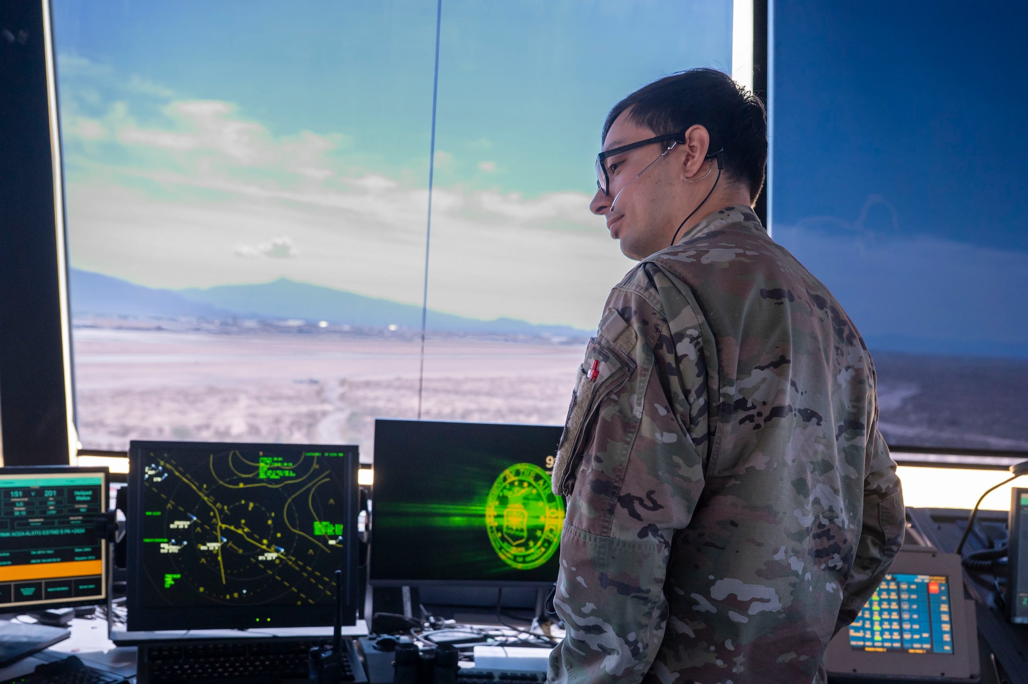 U.S. Air Force Senior Airman Dominic Avila, 563rd Operational Support Squadron air traffic controller, oversees the proper separation of aircraft by issuing verbal control instructions at Davis-Monthan Air Force Base, Arizona, July 23, 2025. Air traffic controllers are responsible for maintaining safe and efficient airspace by coordinating aircraft movement during takeoff, landing and in flight. (U.S. Air Force photo by Airman Samantha Melecio)