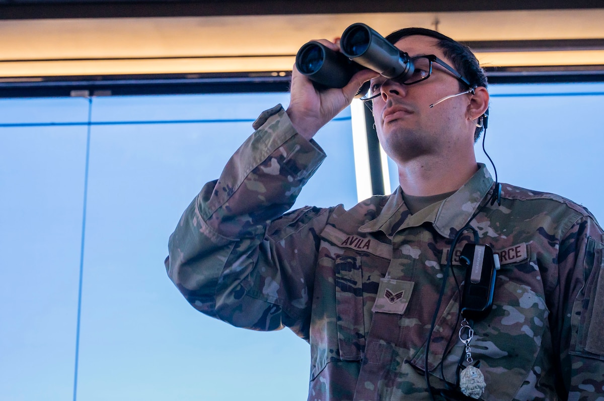 U.S. Air Force Senior Airman Dominic Avila, 563rd Operational Support Squadron air traffic controller, oversees proper separation of aircraft by issuing verbal control instructions at Davis-Monthan Air Force Base, Arizona, July 23, 2025. Air traffic controllers operate under high-stress conditions, where accuracy and timing are essential to successful air operations. (U.S. Air Force photo by Airman Samantha Melecio)
