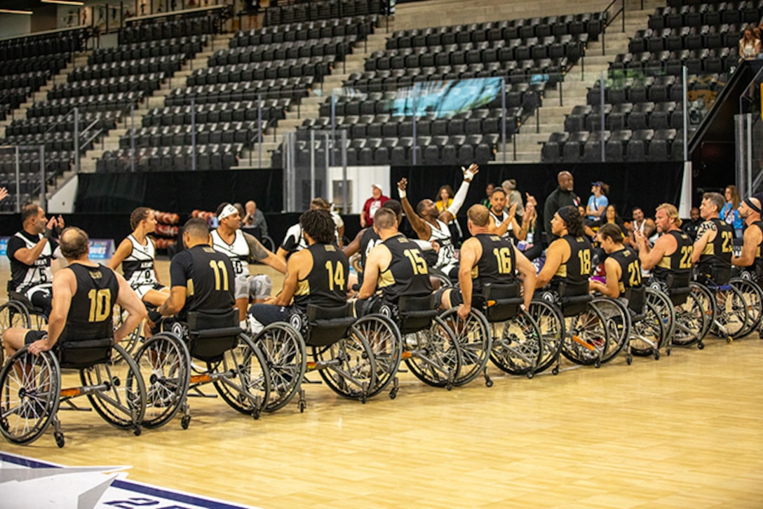Team Army and Team SOCOM line up on the court before the start of the wheelchair basketball gold medal game at the 2025 Department of Defense Warrior Games in Ed Robson Arena, Colorado Springs, Colorado, July 20, 2025.