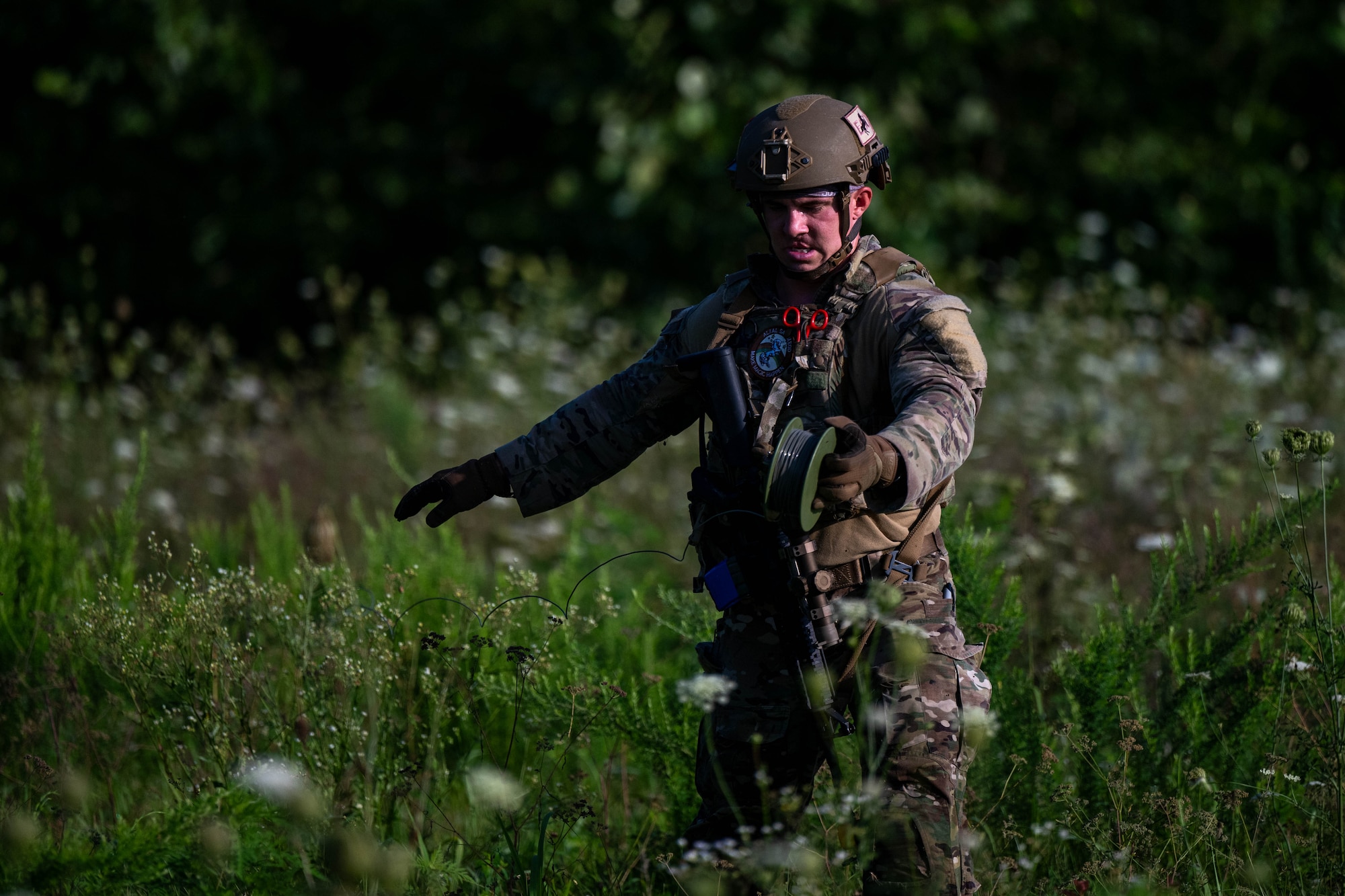 A man unrolls fire in a field