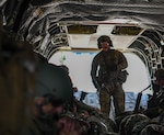 An Ohio National Guard CH-47 Chinook helicopter repairer assigned to Company B, 3rd Battalion, 238th Aviation Regiment, does in-flight inspections during a flight to Wright-Patterson Air Force Base, Ohio, July 14, 2025. The operation highlighted collaboration between Army and Air National Guard units, strengthening inter-branch coordination that is essential for mission success in both domestic and deployed settings.